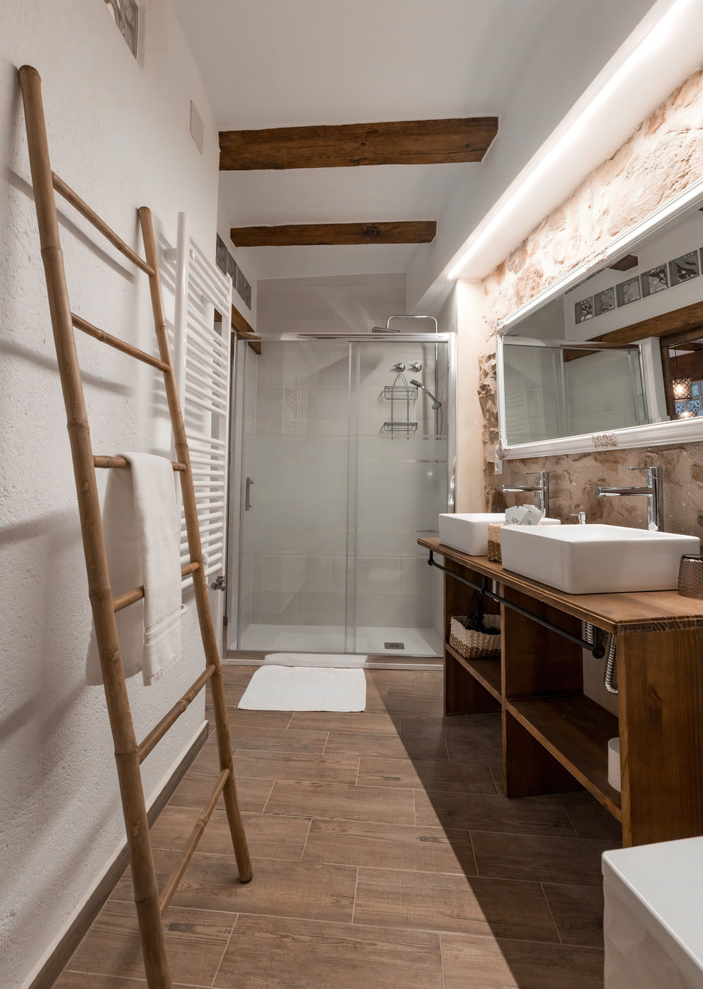Baño moderno con ducha y muebles de madera.