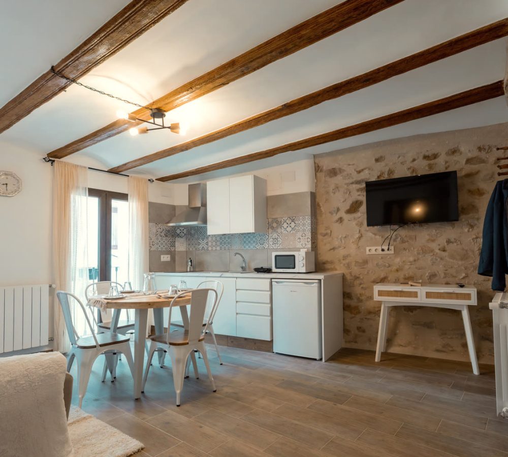 Comedor moderno con cocina y decoración acogedora.